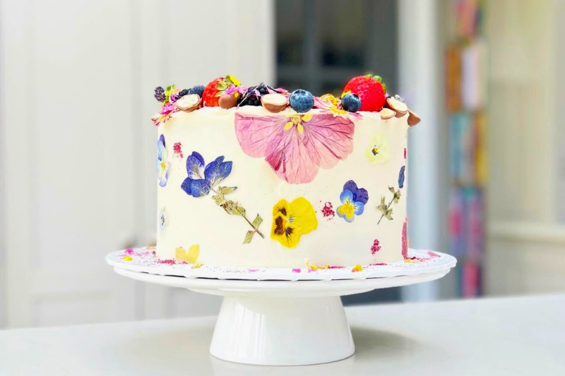 Decorating cake with edible flowers using tools